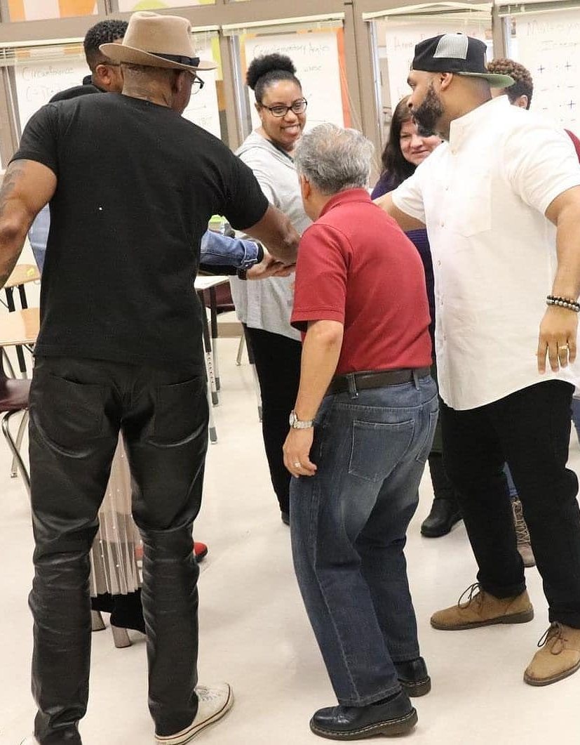 B.O.S.S. facilitators and participants in a hands-on group coaching exercise during a workshop
