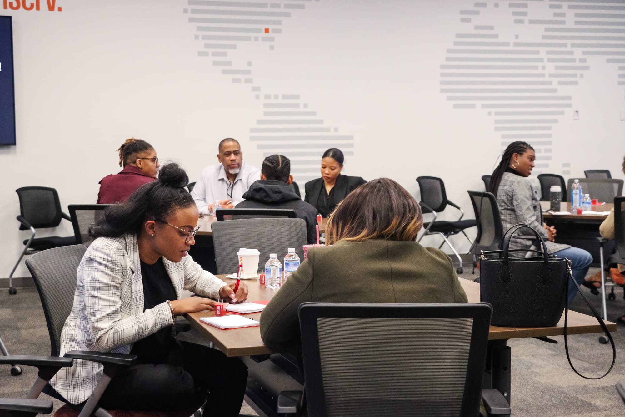 B.O.S.S. facilitators leading a working leadership session with participants taking notes