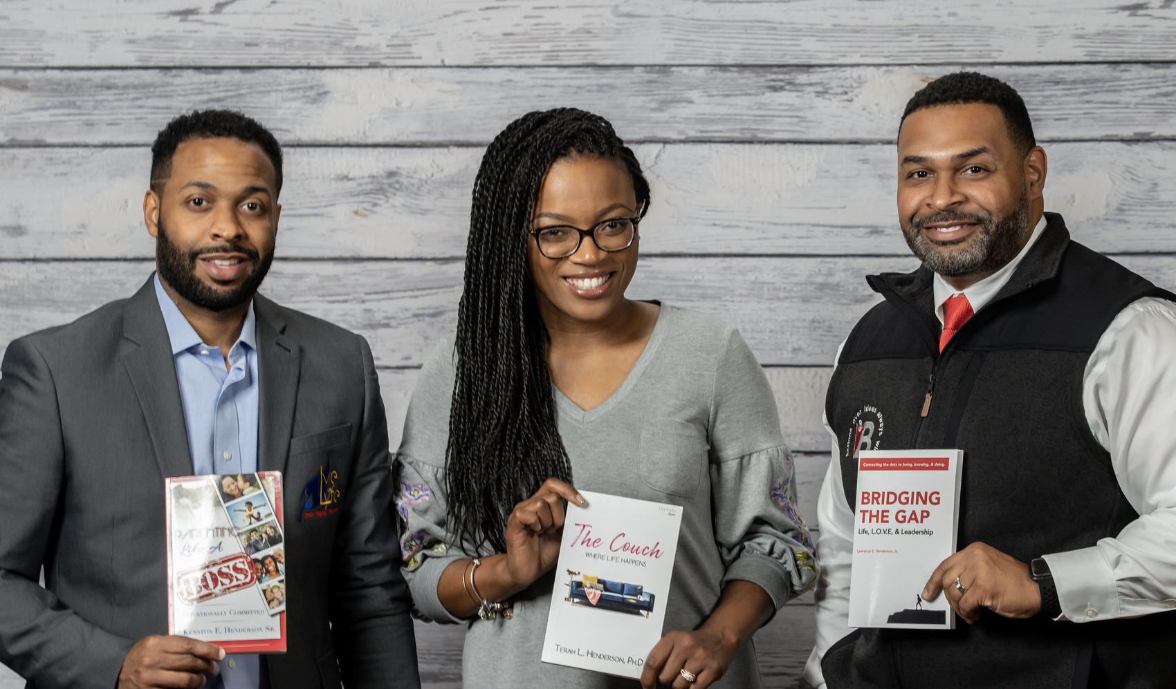 B.O.S.S. consultants holding the firm's published books, including Bridging the Gap: Life, L.O.S.S. & Leadership